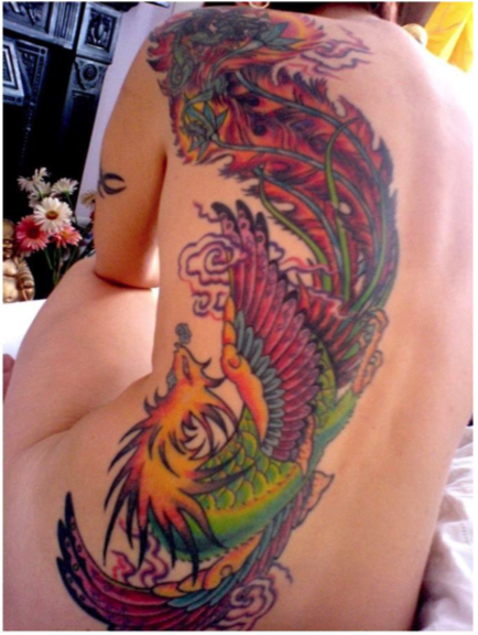 Dragon and phoenix tattoo on woman's back